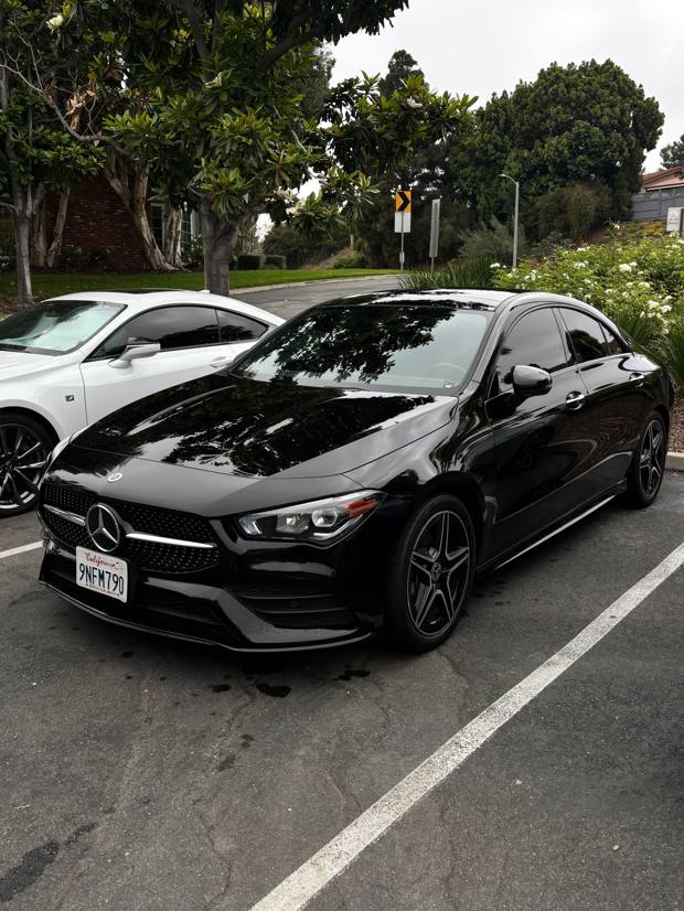 Black Mercedes-Benz CLA with a mirror-gloss paint finish after an Express+ detail